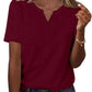 Burgundy women's V-neck button-up t-shirt with short sleeves, paired with denim jeans and layered gold necklaces