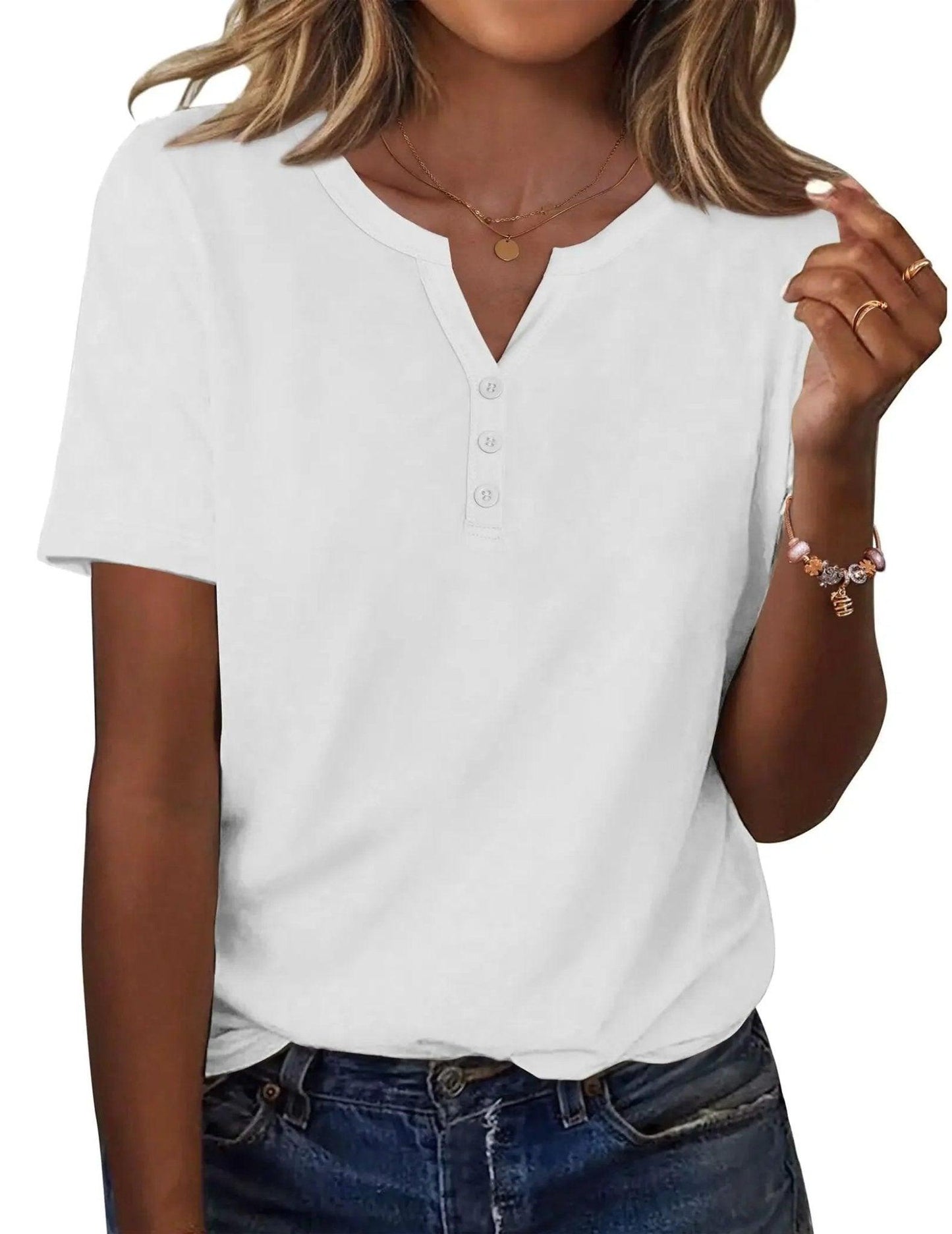 White women's V-neck button-front t-shirt with short sleeves, paired with denim jeans and gold jewelry
