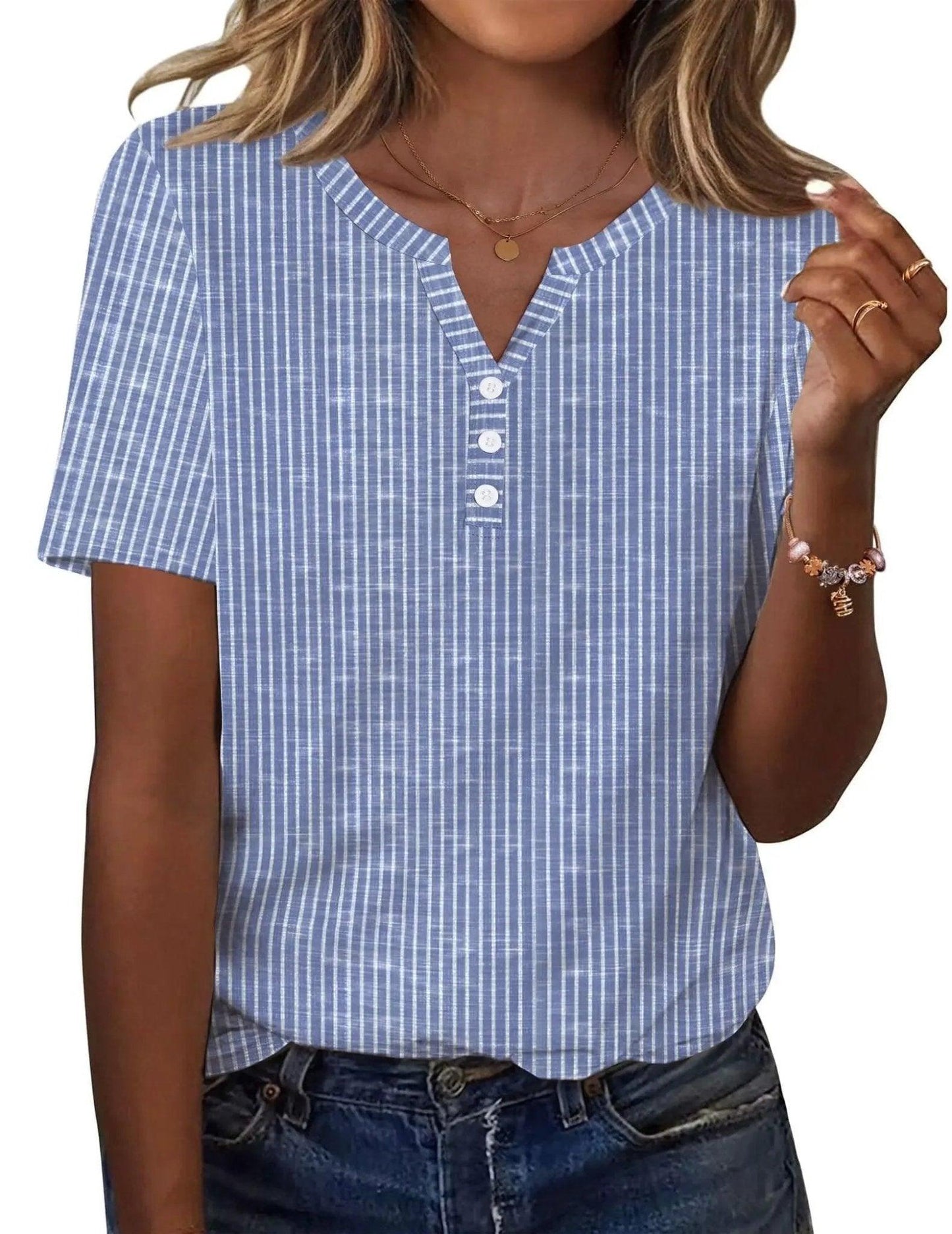 Blue and white striped women's V-neck button-up top with short sleeves, paired with denim jeans