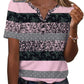 Women's pink and black patterned short sleeve top with button front and V-neck, paired with jeans.